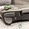 The shoulder button and trigger on the top edge of the PowerA MOGA XP7-X Plus mobile game controller for Android and PC. The shoulder button and trigger on the top edge of the PowerA MOGA XP7-X Plus mobile game controller for Android and PC