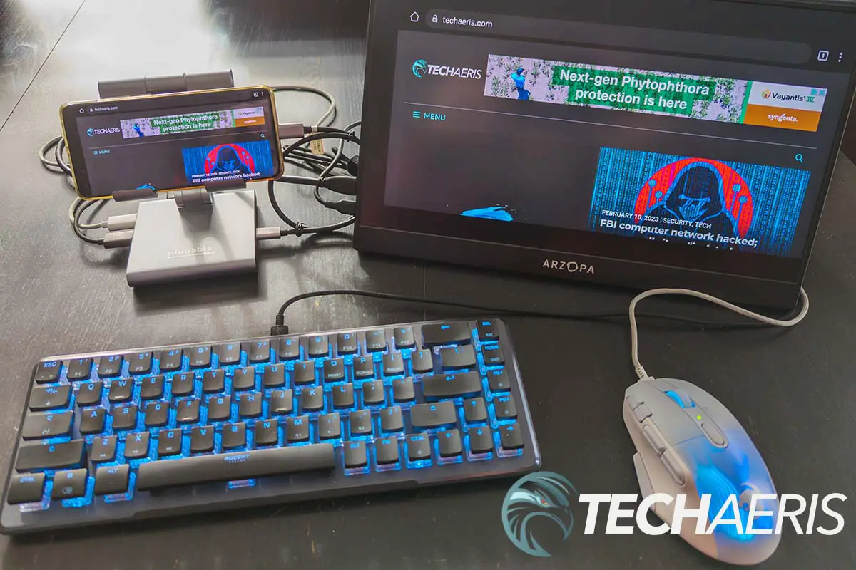 The Plugable UDS-7IN1 USB-C Phone Stand Docking Station with keyboard and mouse attached to a Huawei P40 Pro Android smartphone