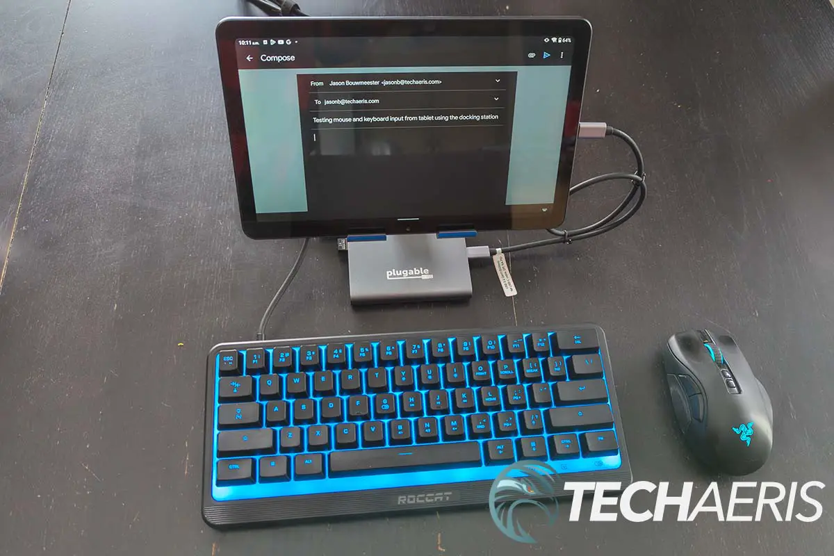 The Plugable UDS-7IN1 USB-C Phone Stand Docking Station with keyboard and mouse attached to a 10" Android tablet