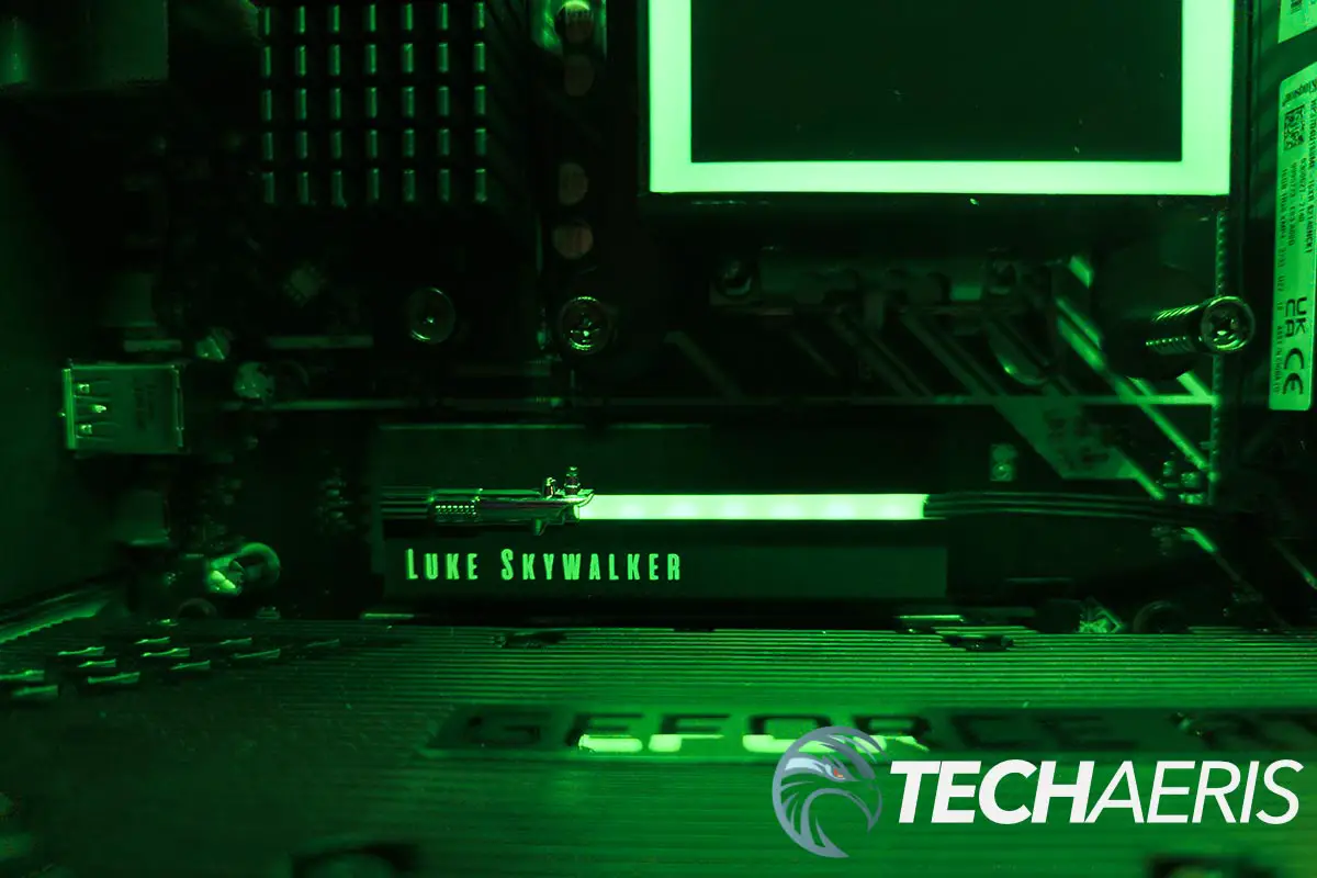 The Seagate Lightsaber Legends Special Edition FireCuda PCIe Gen4 NVMe SSD installed in a computer with green RGB LEDs lit